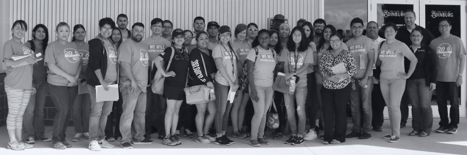 A large group of City of Edinburg volunteers and staff standing together in front of a city building.